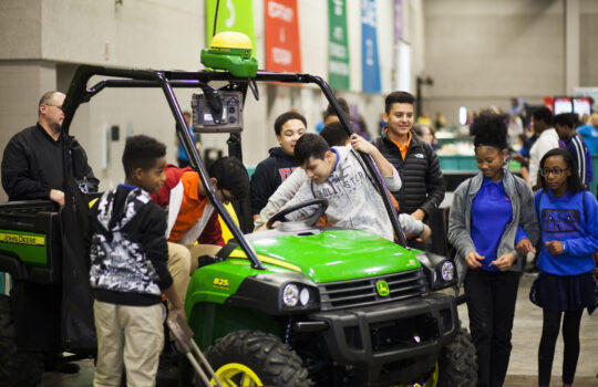 kids riding a green go kart